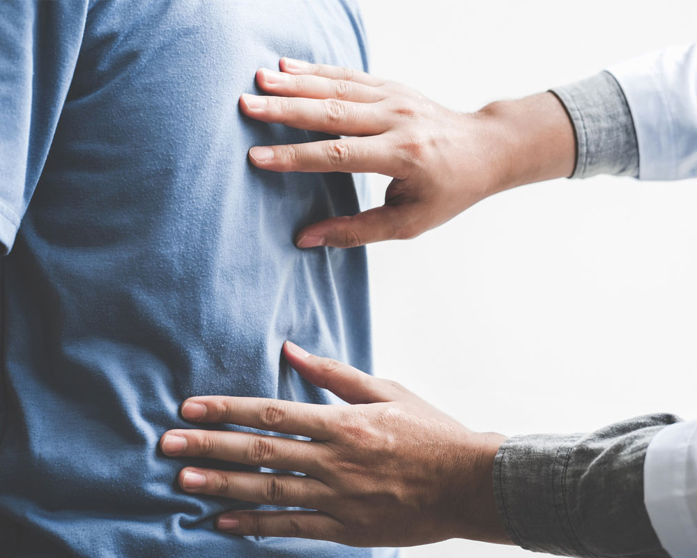 Chiropractor touching a man spine